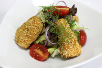 Delicious salad served in a white plate