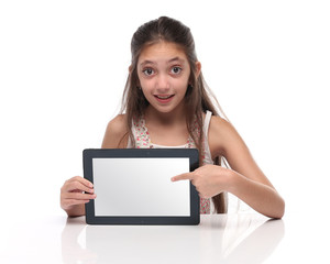 Beautiful pre-teen girl showing a tablet computer. 