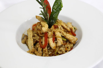 Delicious pasta with spicy sauce in a white plate
