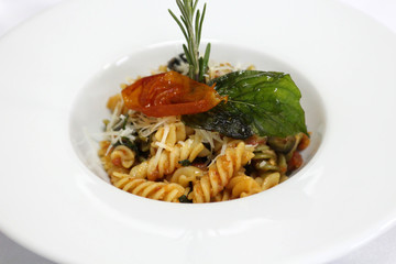 Delicious pasta with spicy sauce in a white plate