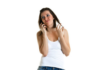 Beautiful young woman with white top talking to the phone