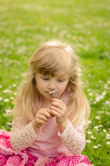 blond girl smelling flowers