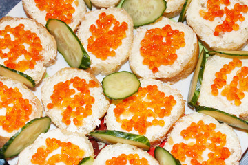 Sandwich with red caviar and cucumber