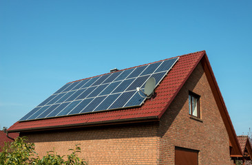 Fototapeta premium Solar panel on a red roof