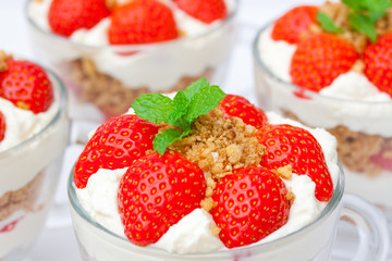 homemade desert with cream chopped cookies and fresh strawberry