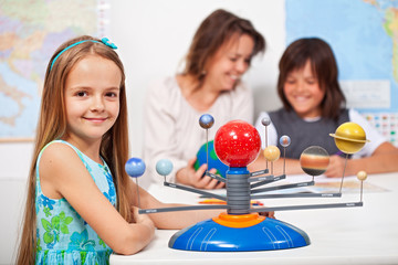 Geography class - little girl learning about the solar system