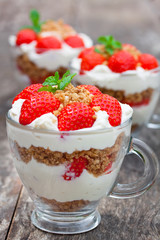 homemade desert with cream chopped cookies and fresh strawberry