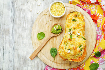 baked pumpkin with millet, vegetables and herbs