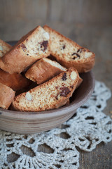 Homemade biscotti with chocolate and almonds in an old clay bowl