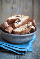 Fototapeta na wymiar Homemade biscotti with chocolate and almonds in an old clay bowl