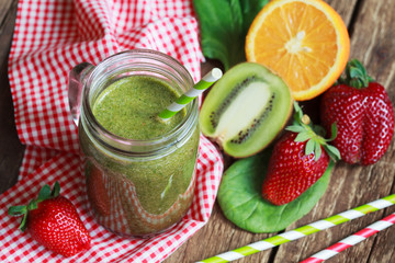 Healthy green smoothie made from spinach, kiwi, strawberries