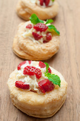 Strawberry Tart with Fresh Cream in Puff Pastry on wooden