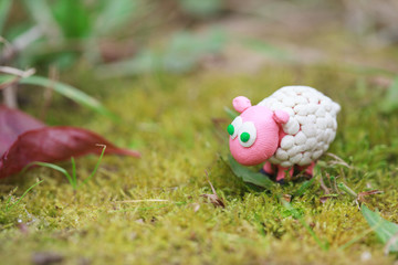 Plasticine world - little homemade white sheep with green eyes