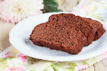Slices of homemade chocolate cake with figs on white plate 