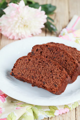 Slices of homemade chocolate cake with figs on white plate 