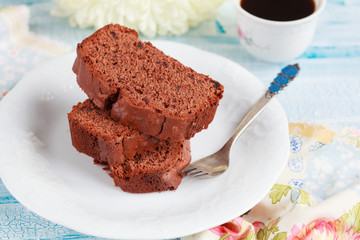 Slices of homemade chocolate cake with figs on white plate 