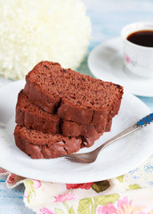 Slices of homemade chocolate cake with figs on white plate 