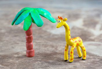 Plasticine world - little homemade yellow giraffe with orange sp