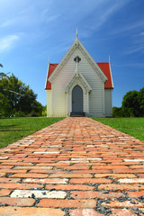 Old wooden church with red brick pathway