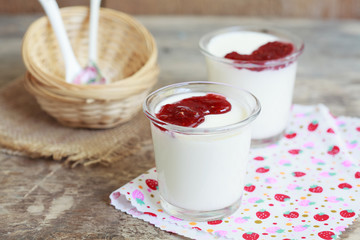 Two small jars homemade yogurt with raspberry jam 