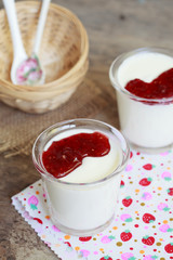 Two small jars homemade yogurt with raspberry jam 