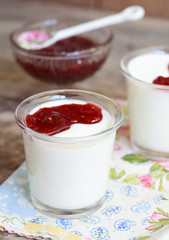 Two small jars homemade yogurt with raspberry jam 