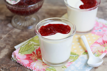 Two small jars homemade yogurt with raspberry jam 