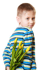 Boy hiding bouquet of flowers behind itself