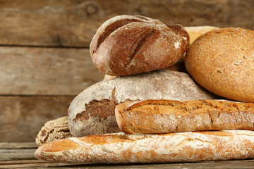 Different fresh bread on old wooden table