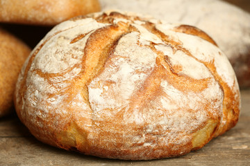 Different fresh bread on old wooden table