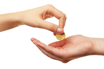 Female hand putting coin into another hand isolated on white
