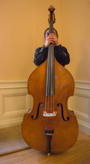 Asian man standing behind  his instruent upright Bass © vermontalm