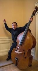 exuberant Asian man with his upright string Bass instrument © vermontalm