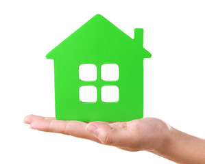 Female hand with small model of house isolated on white