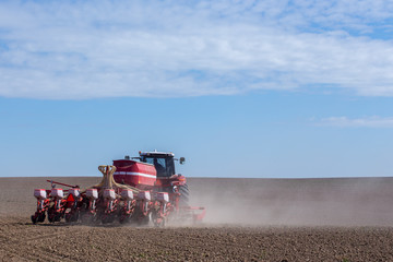 Tractor harrowing the field