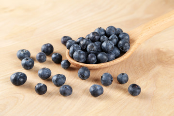 Blueberries in a wooden spoon