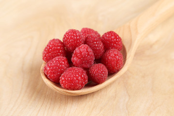 Raspberries in a wooden spoon
