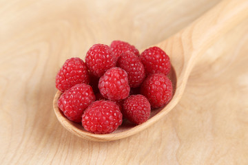 Raspberries in a wooden spoon