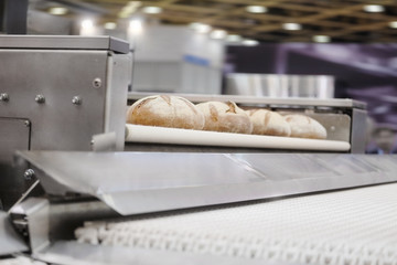 Baked breads on production line at bakery