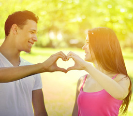 Couple making heart with hands outdoor