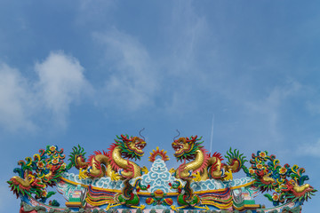 double gold dragon on the shrine roof with sky background