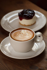 Cup of latte coffee with cake