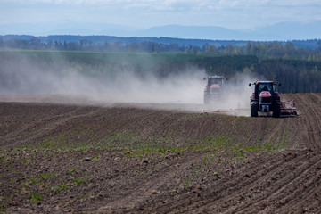 Tractor harrowing the field