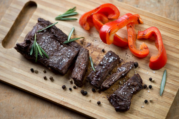 Sliced well-done grilled beef steak machete, high angle view