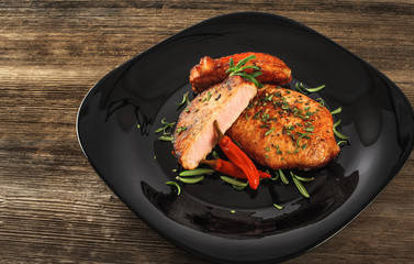 Steak with rosemary and chili pepper on a plate