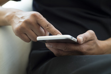 The hands of the men who are using a smartphone