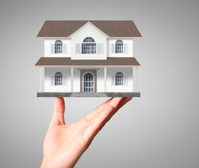 Businessman holding home model