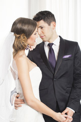 Happy bride and groom embracing