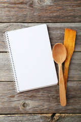 Open blank recipe book on grey wooden background