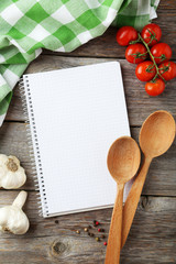 Open blank recipe book on grey wooden background